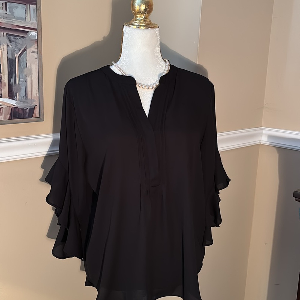 Black crepe blouse with double tiered bell sleeves.